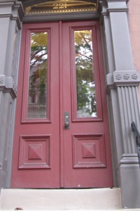 A red door on a home from 1871 in the historic district of Albany, New York