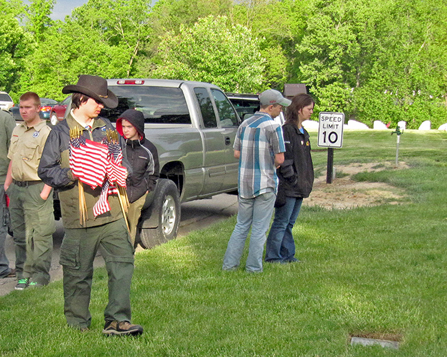 Sebastian with flags to decorate graves